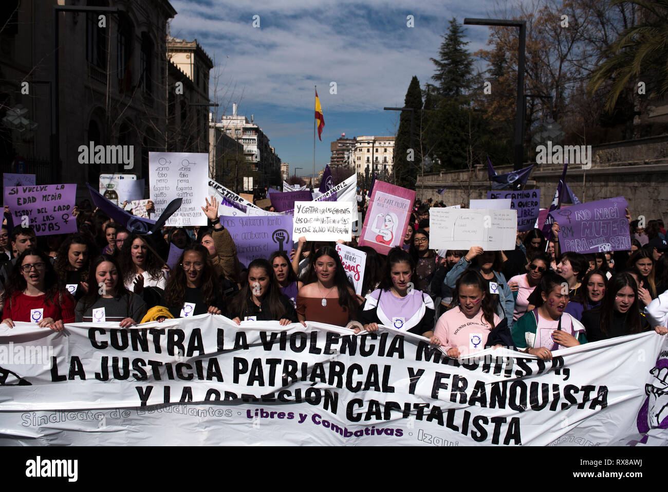 Students seen with a banner and placards along Gran Via street during the strike. Spanish people celebrate International Women's Day with a women's general strike against gender violence. Stock Photo