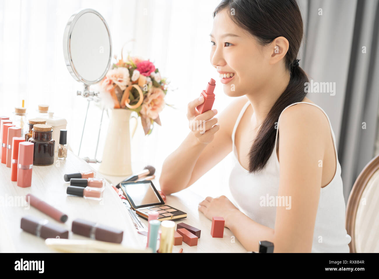 Young Asian female makeup beauty by lipstick Stock Photo