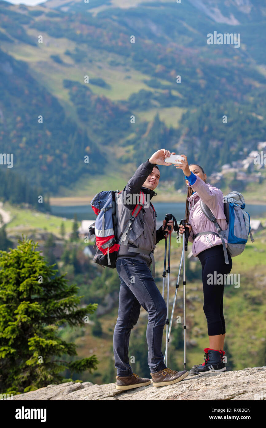 Two hikers taking selfie on top of the mountain Stock Photo - Alamy