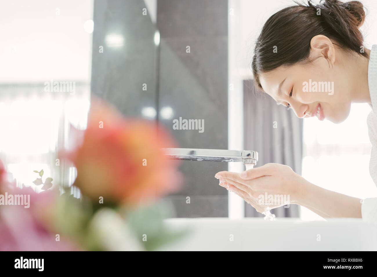 Young Asian WWoman Washing Her Face Stock Photo