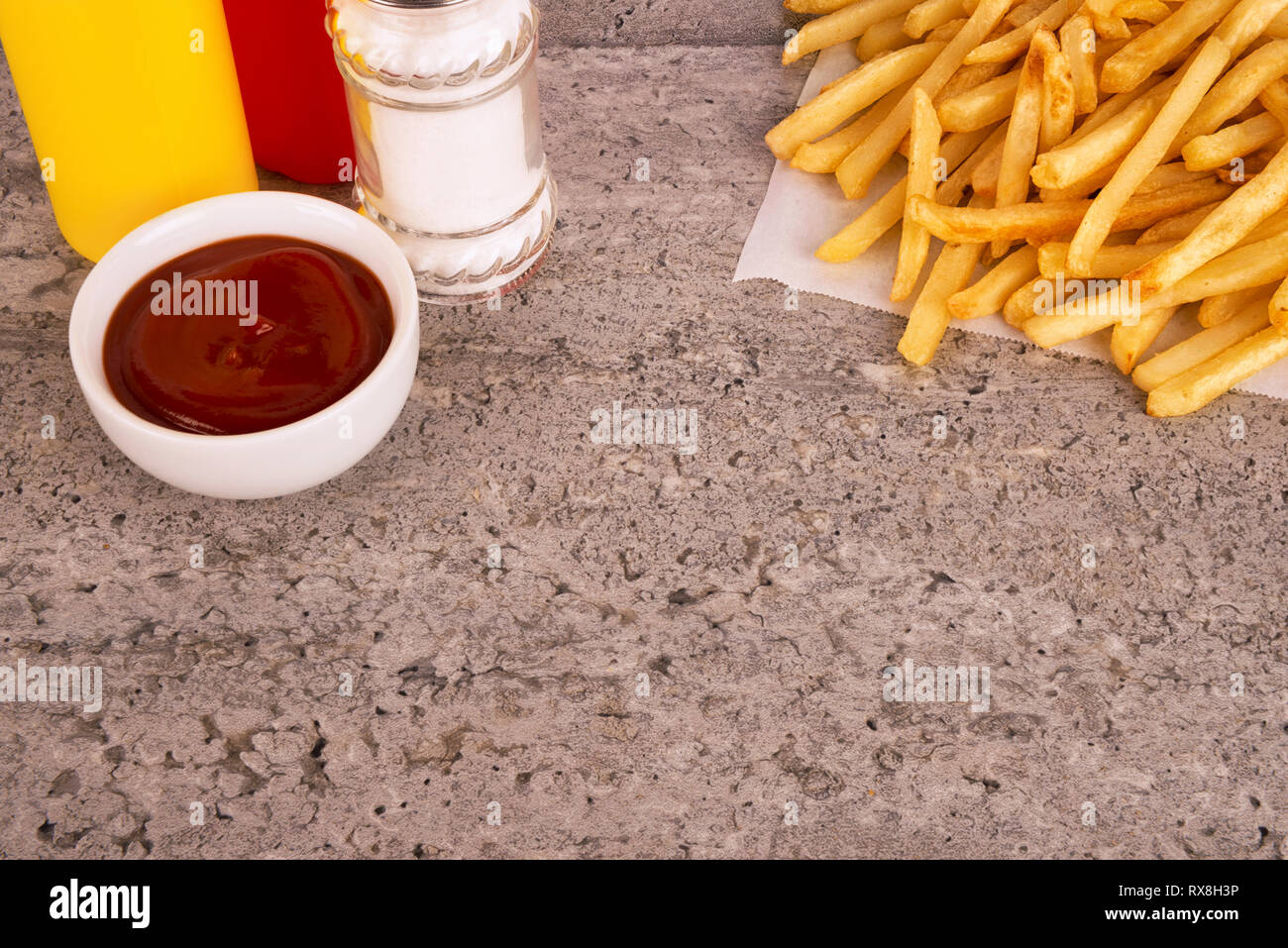 french-fries-on-a-concrete-texture-table-fast-food-restaurant-concept
