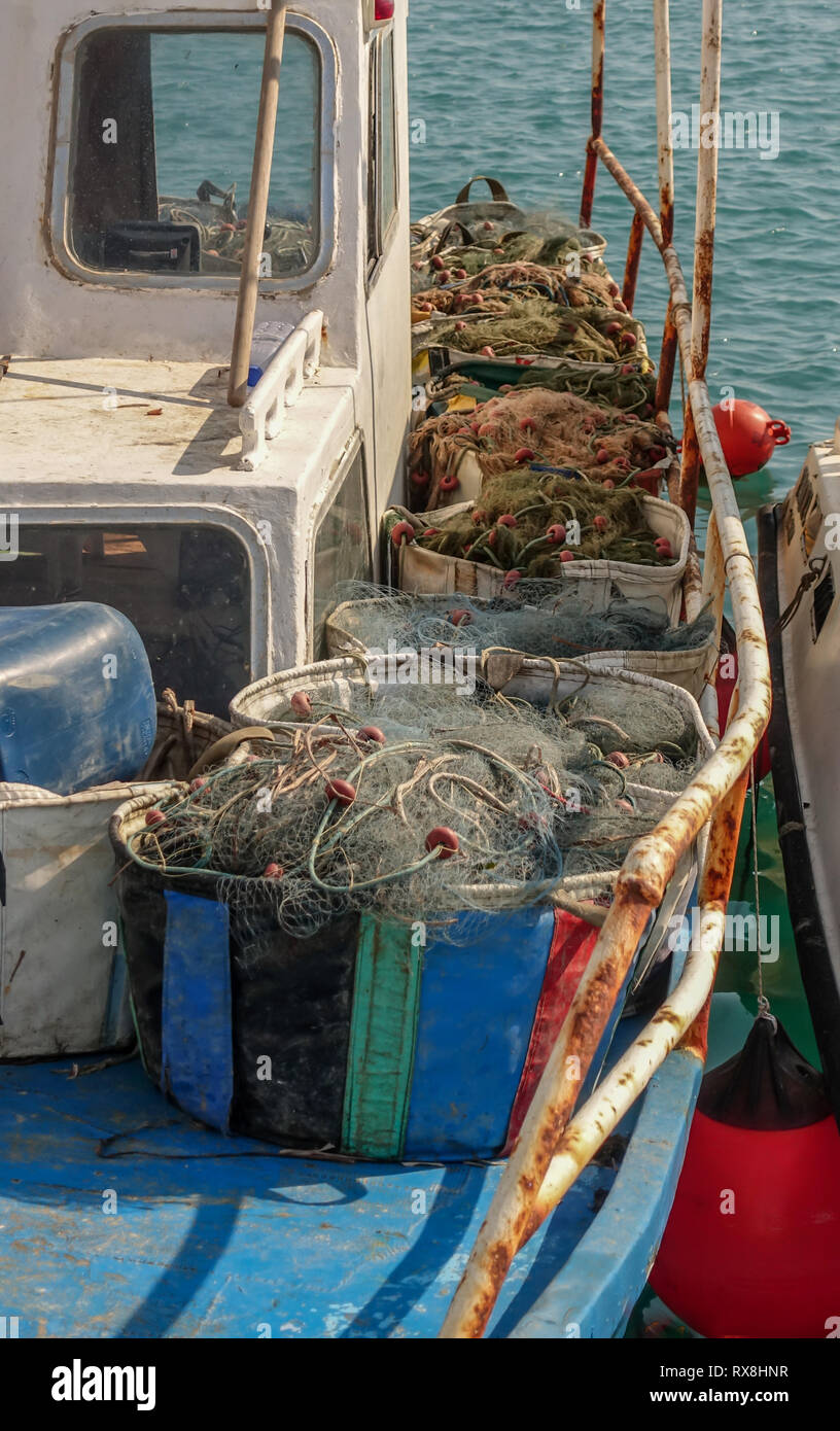 https://c8.alamy.com/comp/RX8HNR/containers-full-of-fishermans-nets-nets-are-lined-up-on-the-deck-of-fishing-boat-portrait-shot-of-half-the-boat-RX8HNR.jpg