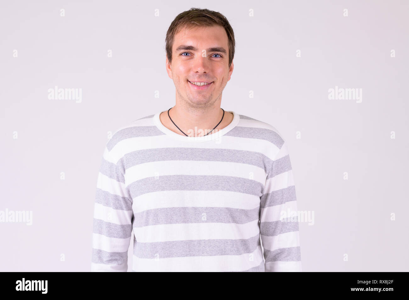Portrait of happy man smiling against white background Stock Photo - Alamy
