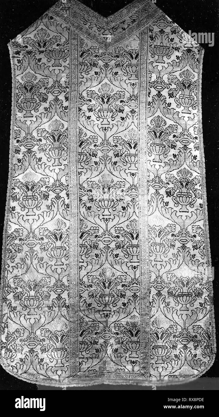 Chasuble. Italy. Date: 1501-1600. Dimensions: 116.8 x 69.4 cm (45 7/8 x 27 1/4 in.)  Repeat: 28.6 x 17.2 cm (11 1/4 x 6 3/4 in.). Silk, plain weave with supplementary patterning wefts and plain interlacings of secondary binding warps and silvered-metal strip supplementary facing and some supplementary patterning wefts; tapes of silk, gilt-metal strips, and gilt-metal-strip-wrapped silk, inner tape: plain weave with supplementary patterning warps; edge tape: plain weave self-patterned by warp and weft floats; lined with linen, plain weave; glazed. Origin: Italy. Museum: The Chicago Art Institut Stock Photo