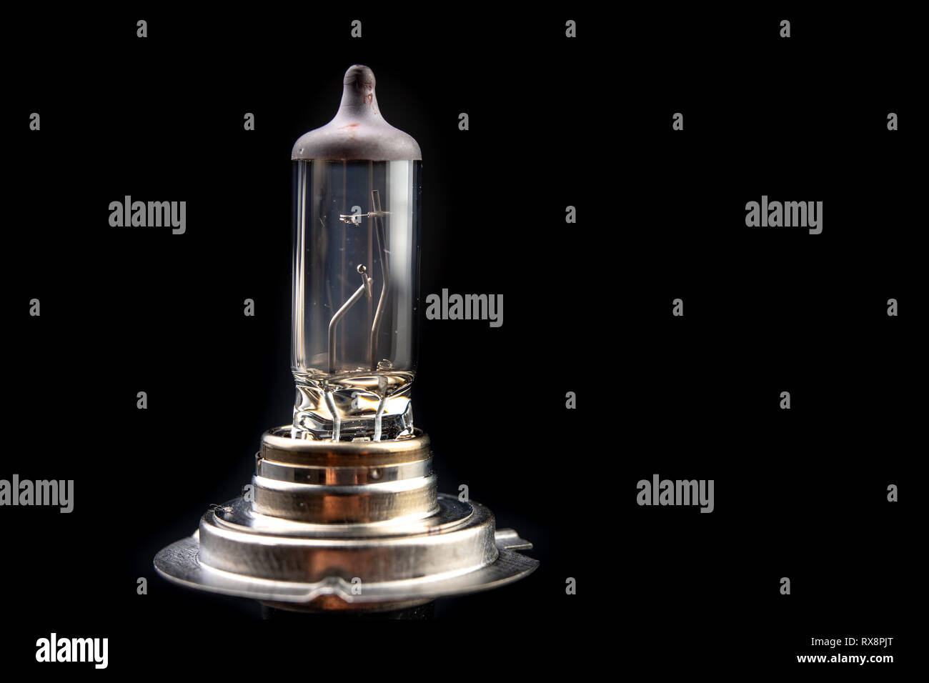 Blown bulb for the car headlight. Car accessories on a workshop black  table. Dark background Stock Photo - Alamy