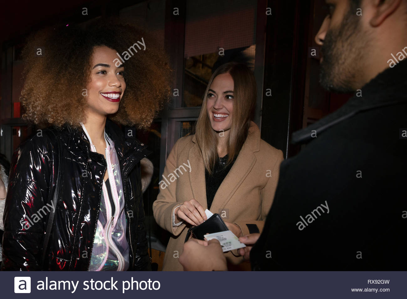 Women friends showing IDs to bouncer Stock Photo Alamy