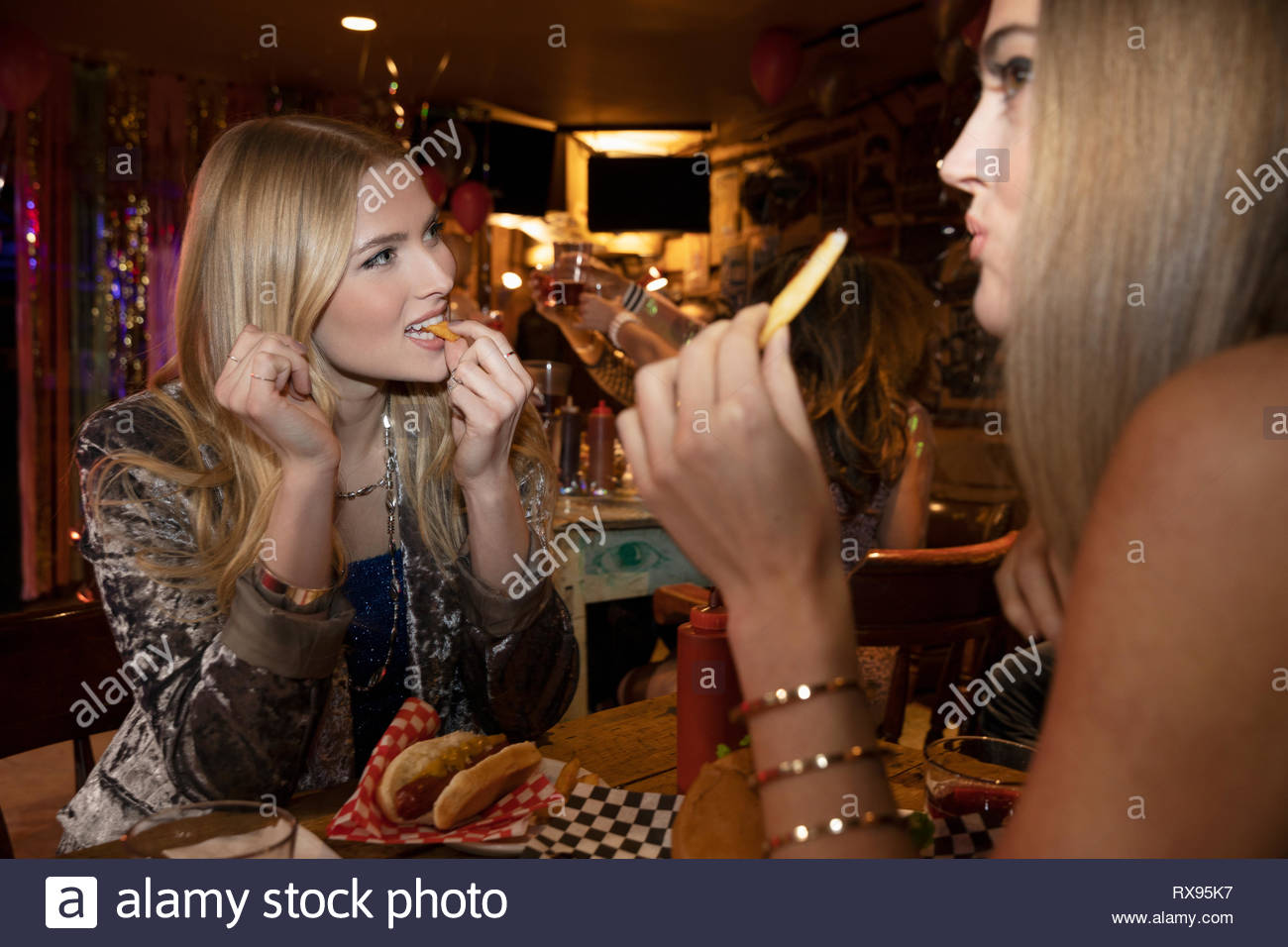 Women friends eating at late night diner Stock Photo Alamy