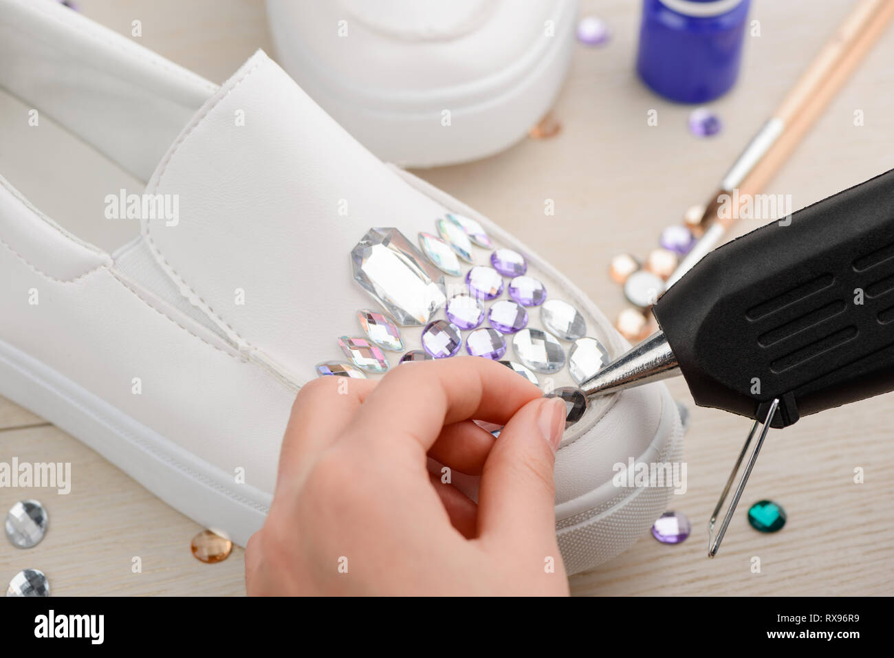 Put Rhinestone On Boot Girl putting rhinestones onto shoe Stock Photo - Alamy