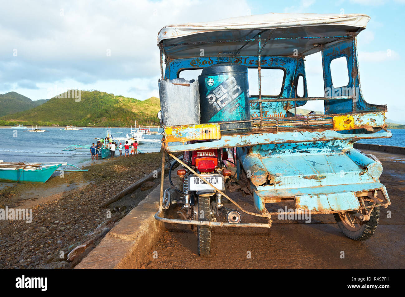 Taytay, Palawan Province, Philippines: Rear view of a blue colored old tricycle parking at a fishermen area late afternoon Stock Photo