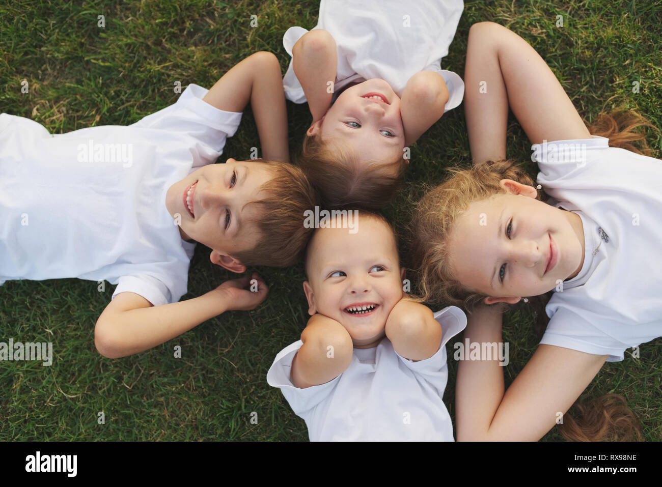 Group happy children lying on hi-res stock photography and images - Alamy