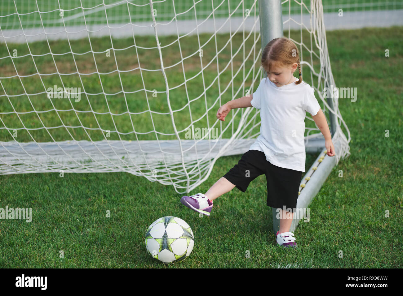 Kid football soccer playing girl hires stock photography and images
