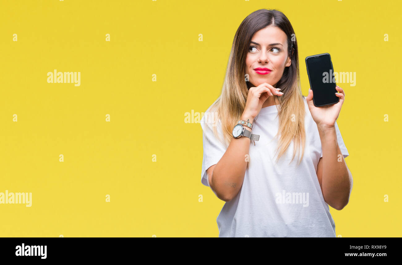Young beautiful woman showing blank screen of smartphone over isolated ...