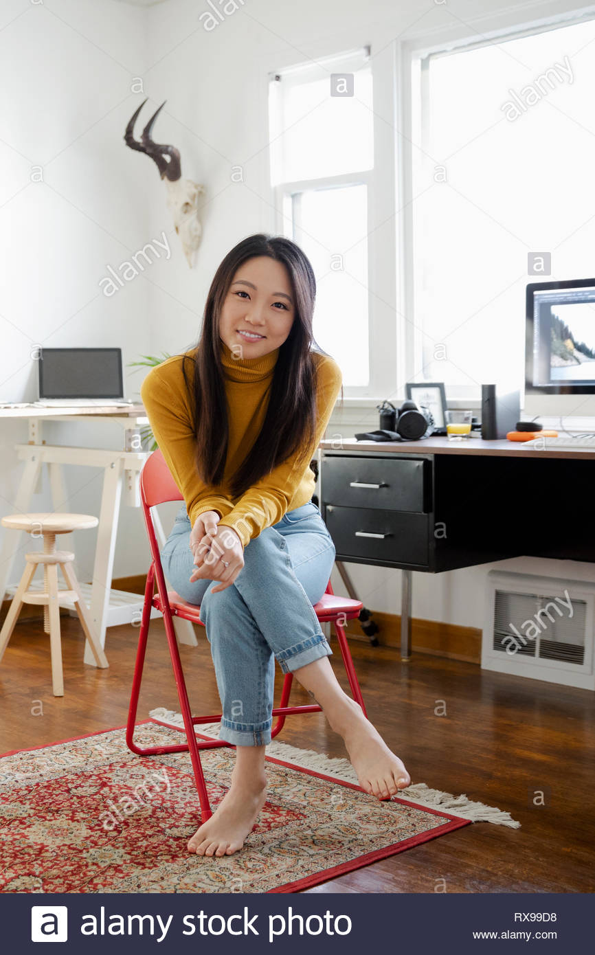 Portrait confident young woman working in home office Stock Photo