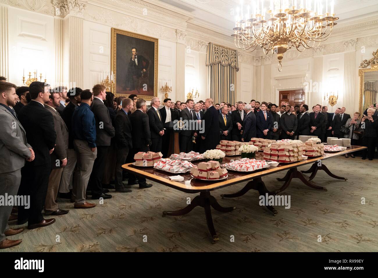 U.S President Donald Trump welcomes players with the 2018 FCS Division I Football National Champions North Dakota Bisons to a lunch of fast-food in the State Dining Room of the White House March 4, 2019 in Washington, DC. Stock Photo