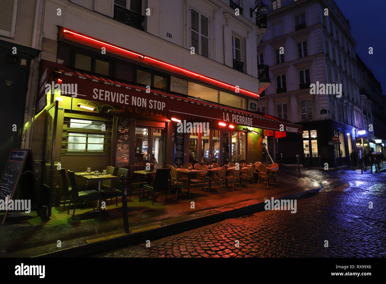 The Cafe La Pierrade is a cafe in the Montmartre at rainy night , Paris ...
