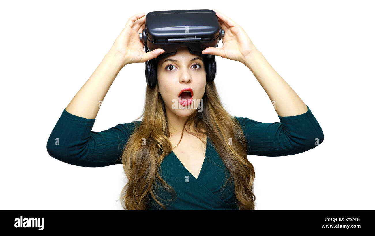 Image of shocked young lady wearing virtual reality device over white ...