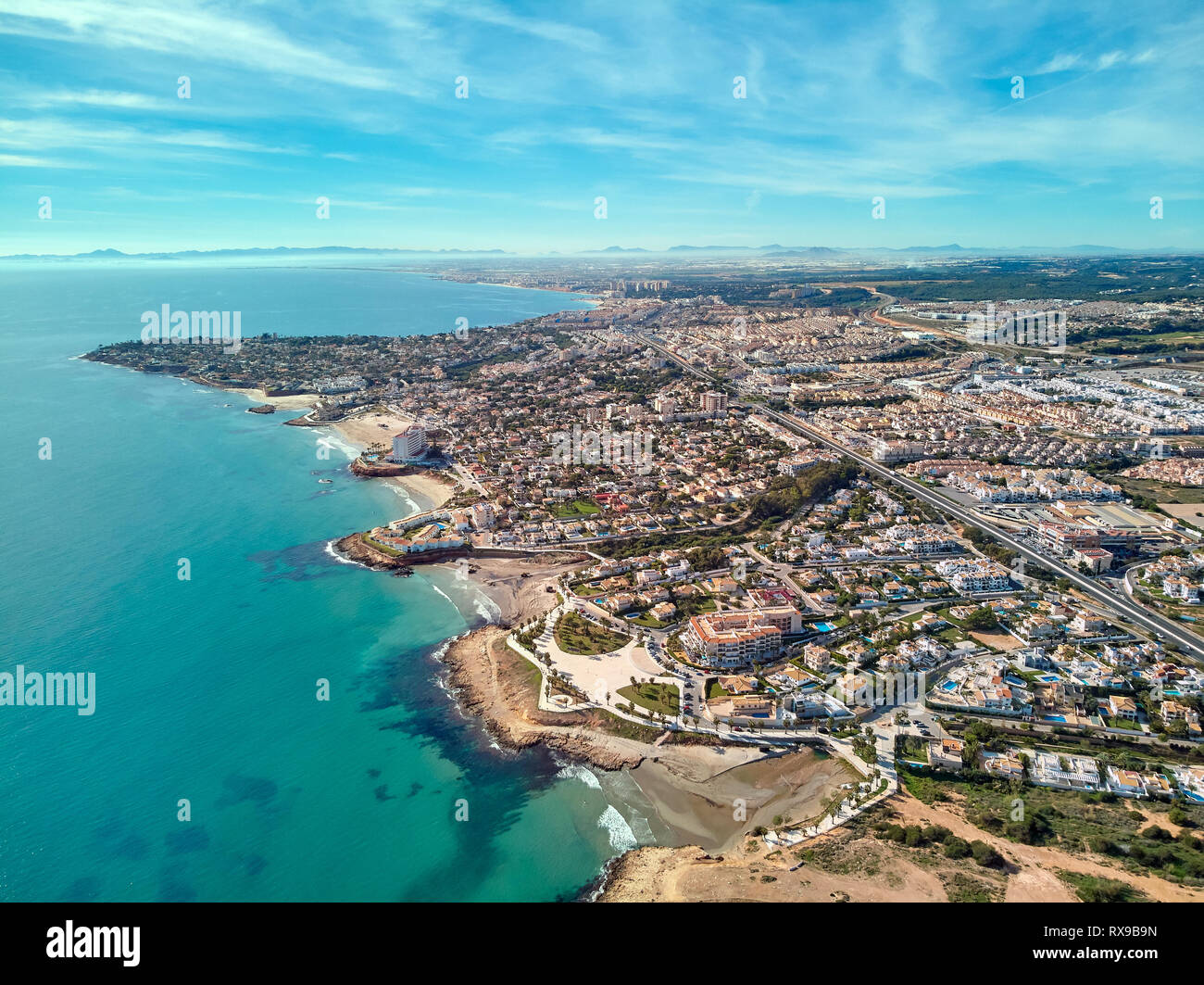 Costa Blanca view from above, drone point of view aerial photography. Turquoise green water rocky coastline, sandy beaches. Cityscape Torrevieja Spain Stock Photo