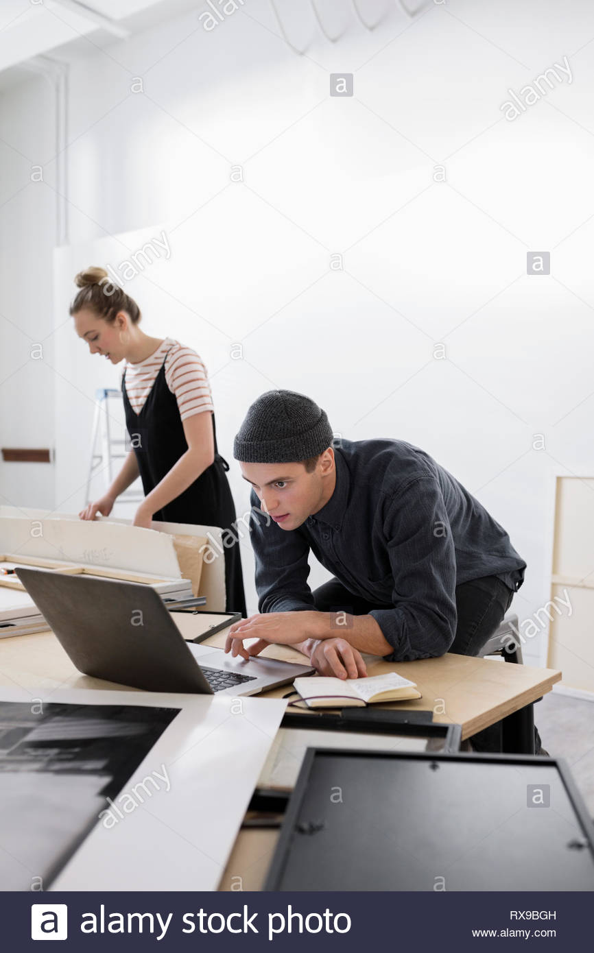 art-gallery-owner-working-at-laptop-stock-photo-alamy