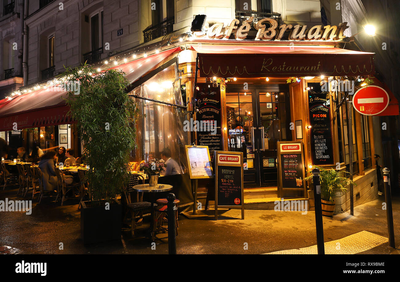 The Cafe Bruant is a cafe in the Montmartre at rainy night , Paris, France. Stock Photo
