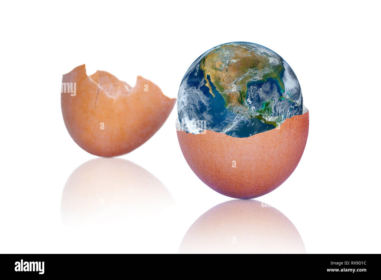 Cracked brown egg showing birth of our planet earth inside. Concept of our fragile planet. Elements of this image furnished by NASA. Stock Photo