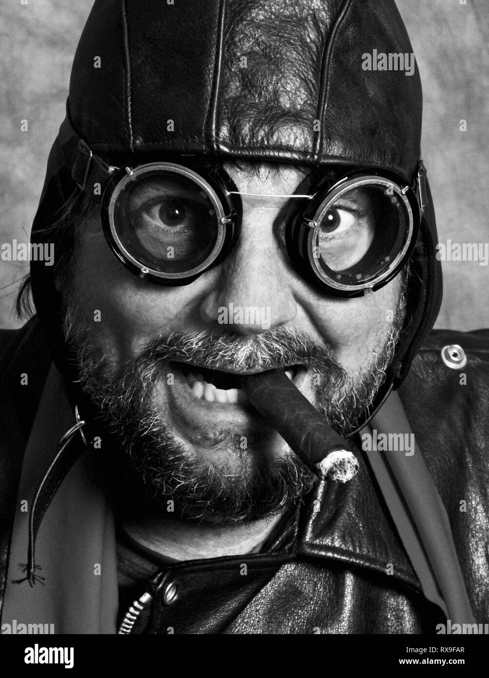 World War Two Fighter Pilot in Leather and Goggles Smoking a Cigar Stock Photo