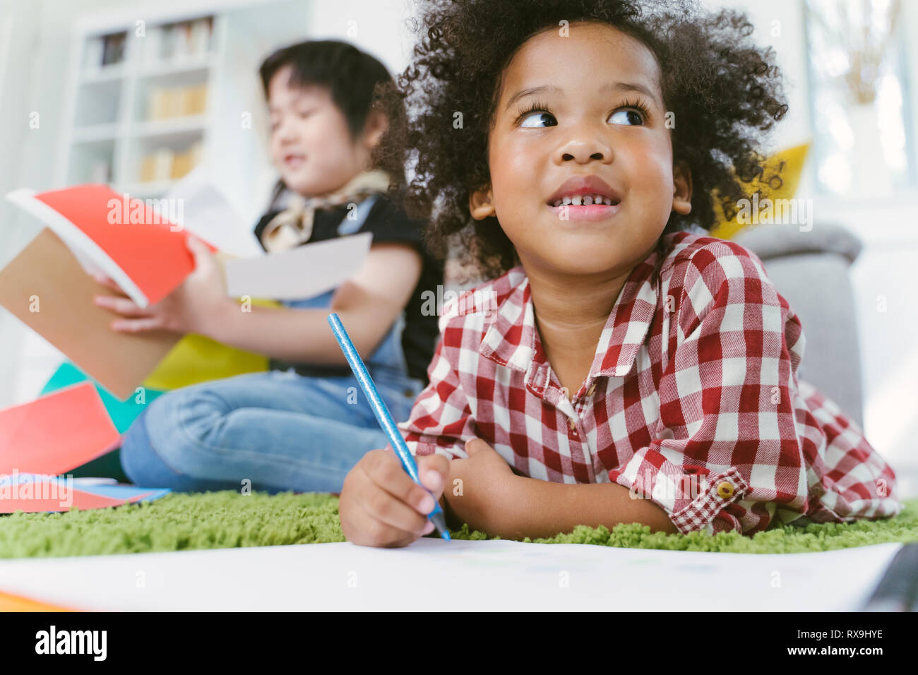 Group of little preschool kids drawing paper with color pencils