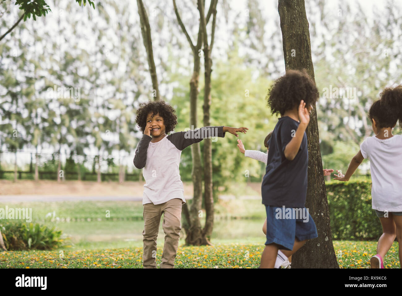kids playing outdoors with friends. little children play at nature park. Stock Photo