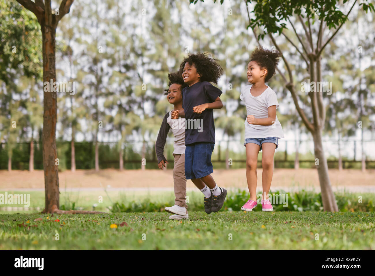 kids playing outdoors with friends. little children play nature park Stock Photo - Alamy