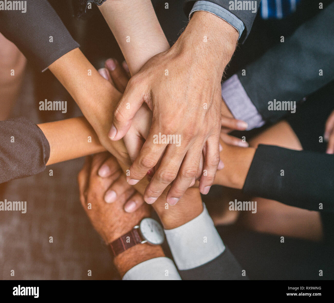 Hand of team stack hands support teamwork Stock Photo - Alamy