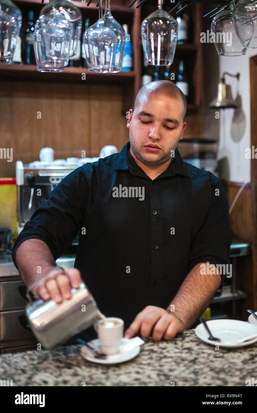 Male barista making coffee at counter in cafe Stock Photo Alamy