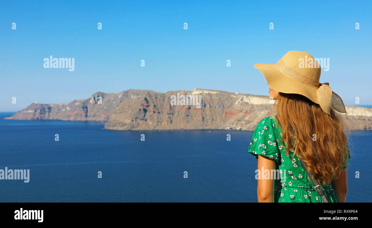 Fashion girl in Santorini. Back view of attractive woman visiting Europe. Stock Photo