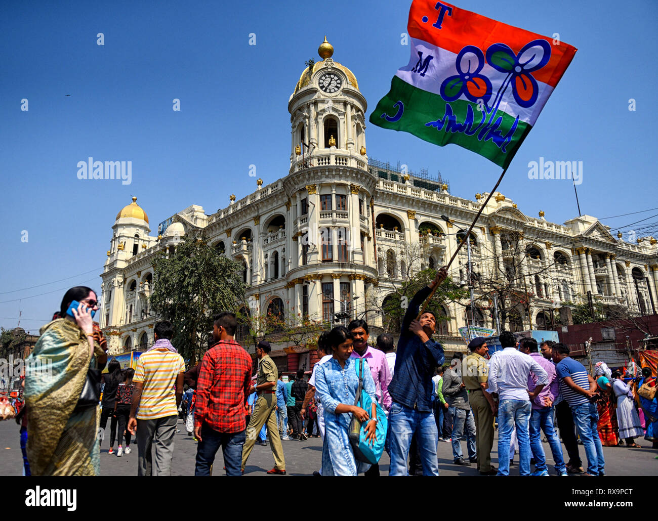 A supporter of Trinamool Congress seen waving the Flag of Trinamoll Congress on the main street of Kolkata. Stock Photo