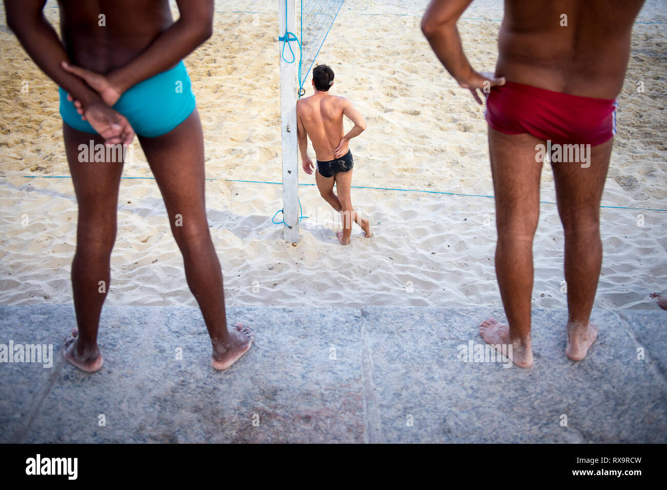 Unrecognizable young men stand on the beach in sunga, a local style of  swimwear popular in Rio de Janeiro, Brazil Stock Photo - Alamy