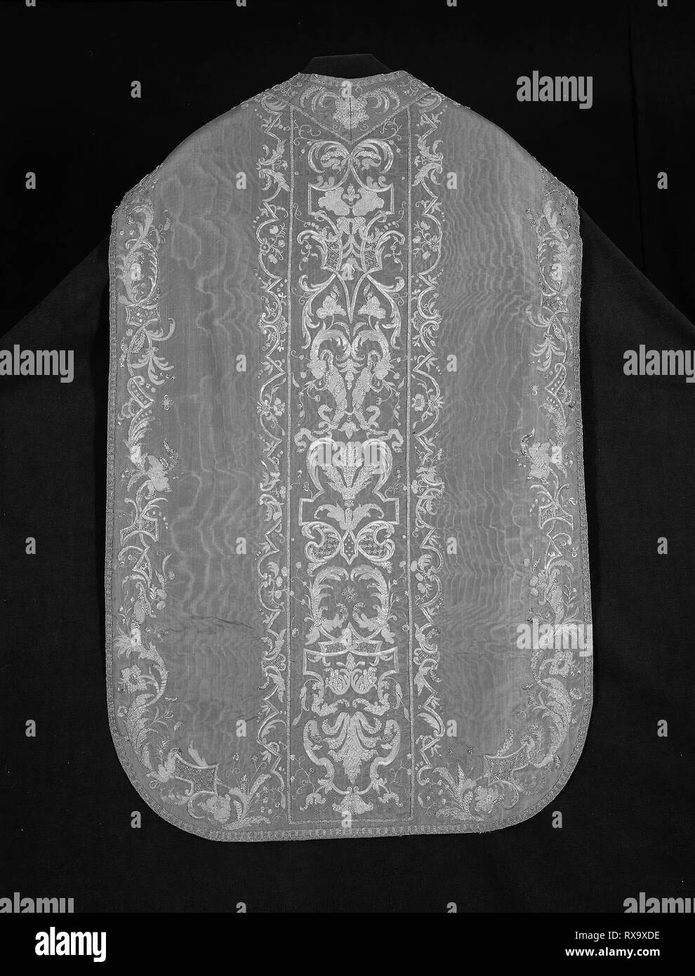 Chasuble, Stole, and Maniple. France or Italy. Date: 1675-1725. Dimensions: a: 112 × 75 cm (44 1/8 × 29 1/2 in.)  b: 209 × 23.2 cm (82 1/4 × 9 1/8 in.)  c: 50.7 × 22.2 cm (20 × 8 3/4 in.). Silk, warp-faced, weft-ribbed plain weave; watered (moiré); underlaid with linen, plain weave; embroidered with gilt-metal strips, spangles, pieces, and wire, and gilt-metal-strip-wrapped silk (file and frisé), in laid work, couching, padded couching, and French knots; edged with gilt-metal-strips and gilt-metal-strip-wrapped silk, bobbin-made tapes. Origin: France. Museum: The Chicago Art Institute. Stock Photo