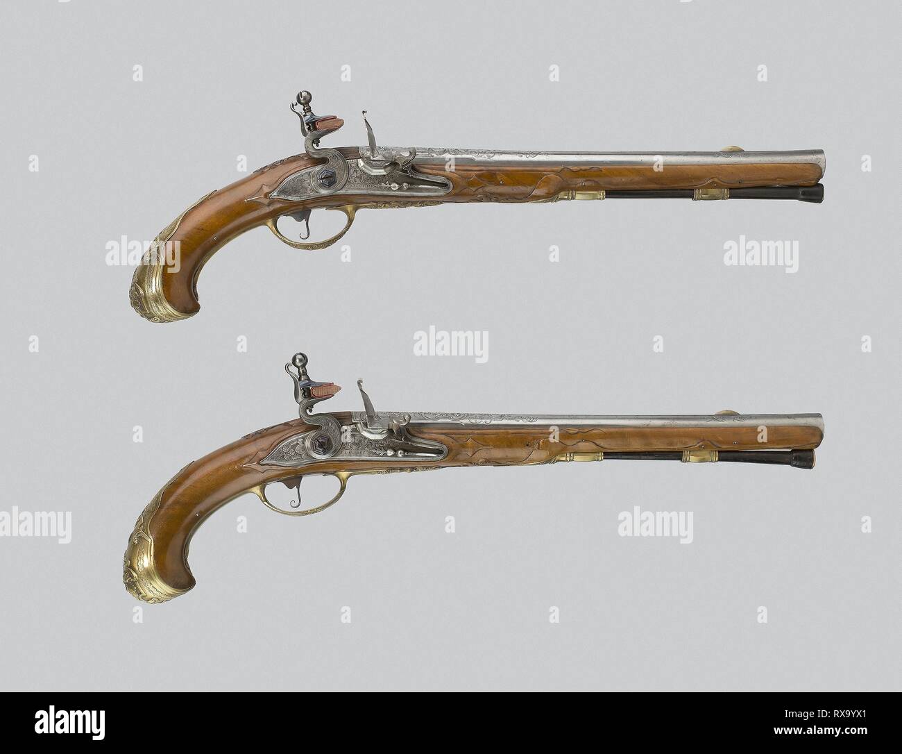 Pair of Flintlock Pistols. Barrels: Johann Jacob Behr; Locks: Johann Jacob Behr; Flemish, Liège, active 1690s-about 1745. Date: 1720-1735. Dimensions: L. 49 cm (19 1/4 in.)  Barrel L. 33 cm (13 in.)  Caliber .66  Wt. 2 lb. 9 oz. each. Walnut, steel, and cast and chased brass. Origin: Germany. Museum: The Chicago Art Institute. Author: J. J. Behr. Stock Photo