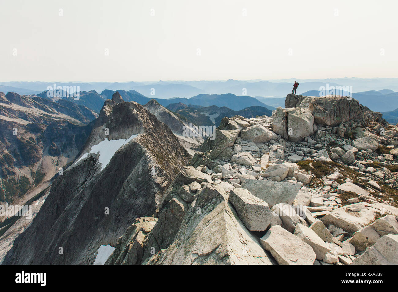 Mid distance view of hiker standing on mountain against sky Stock Photo ...