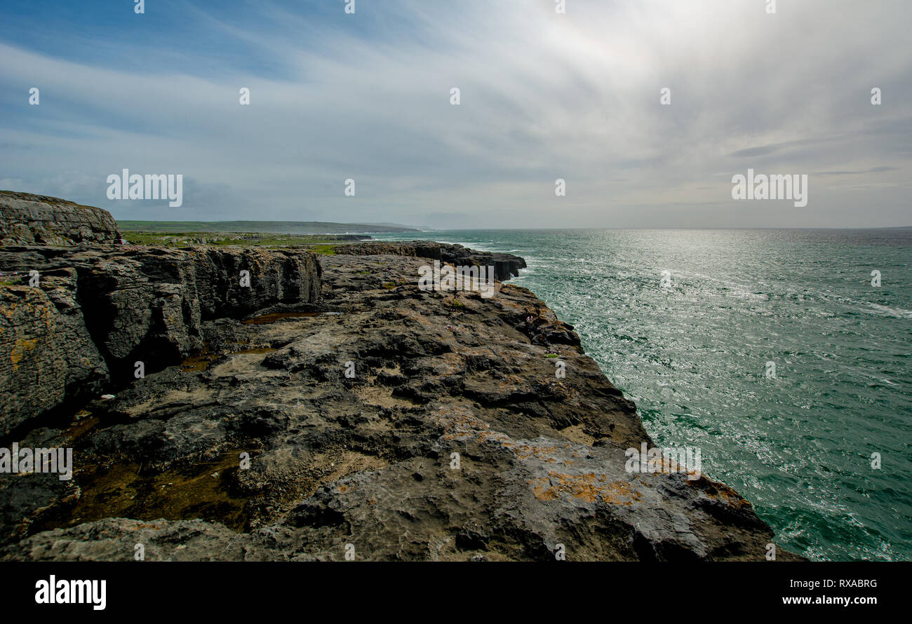 Rugged Irish coastline in the Burren with clouds Stock Photo
