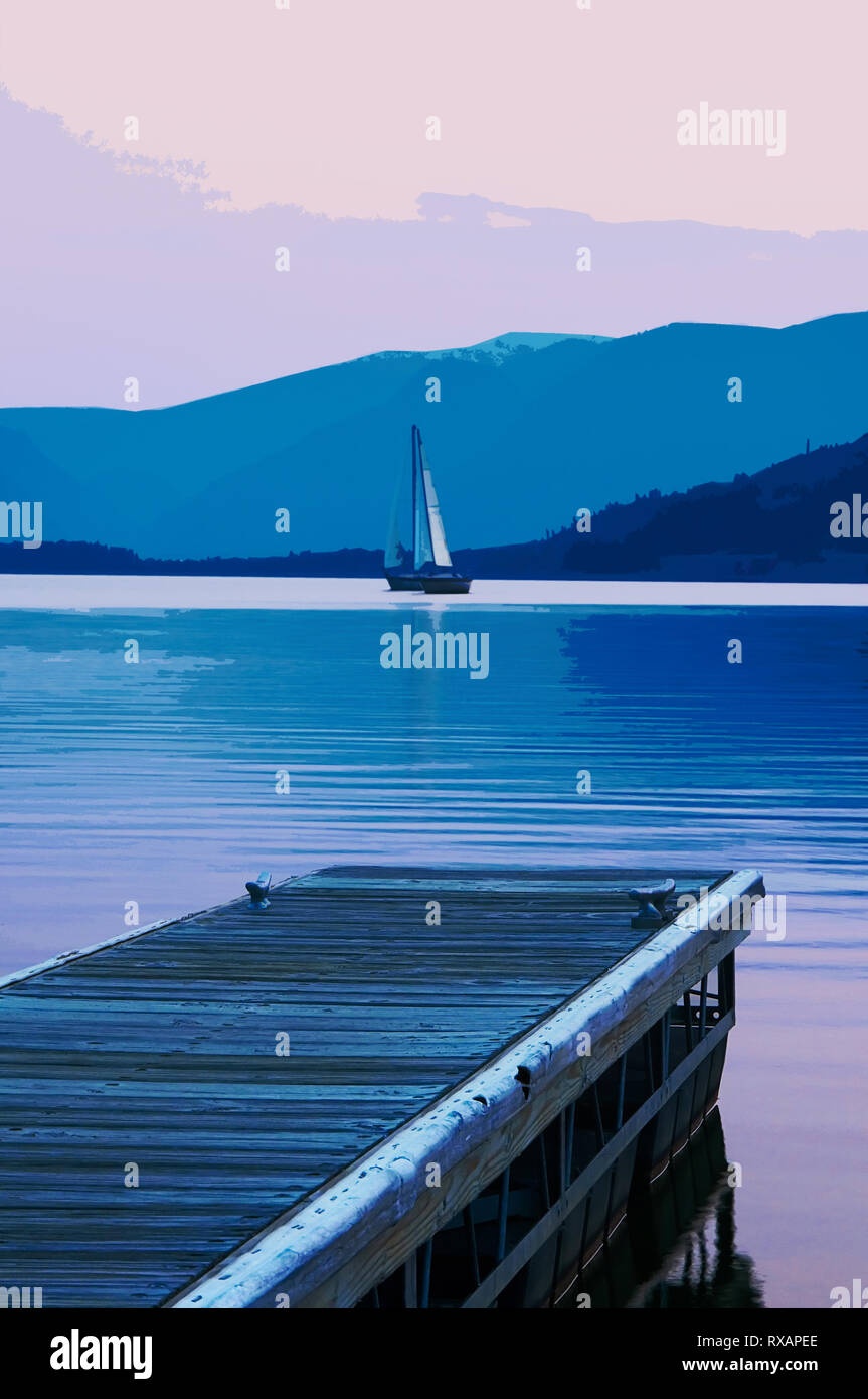 A sailboat at Lake Dillon in the Colorado Rocky Mountains at dusk.  Fine art photography.  Exclusive. Stock Photo