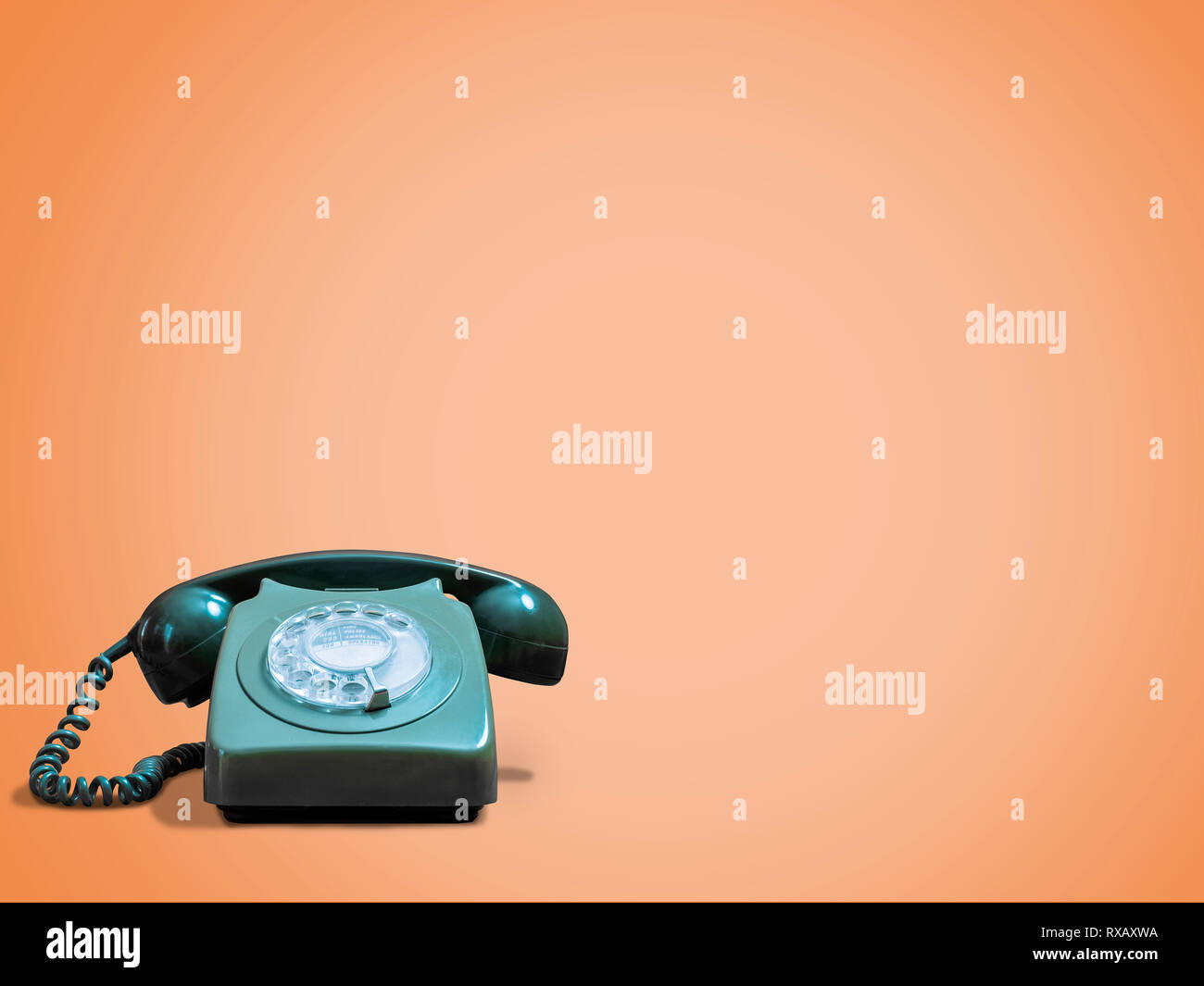 Vintage telephone against orange background Stock Photo