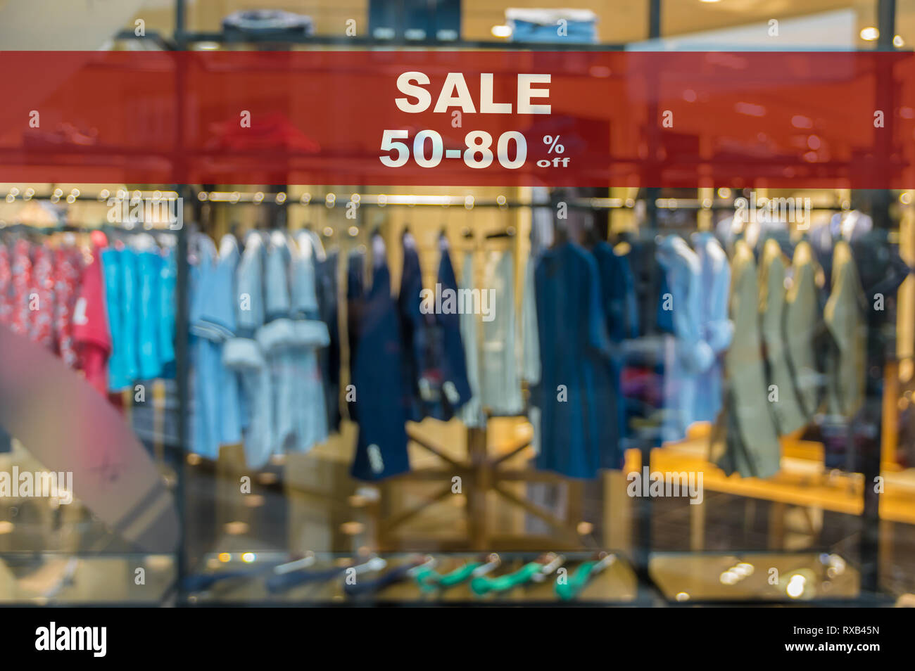 Sale 50-80% off mock up advertise display frame setting over the Abstract blurred photo of clothing store in a shopping mall, shopping concept Stock Photo