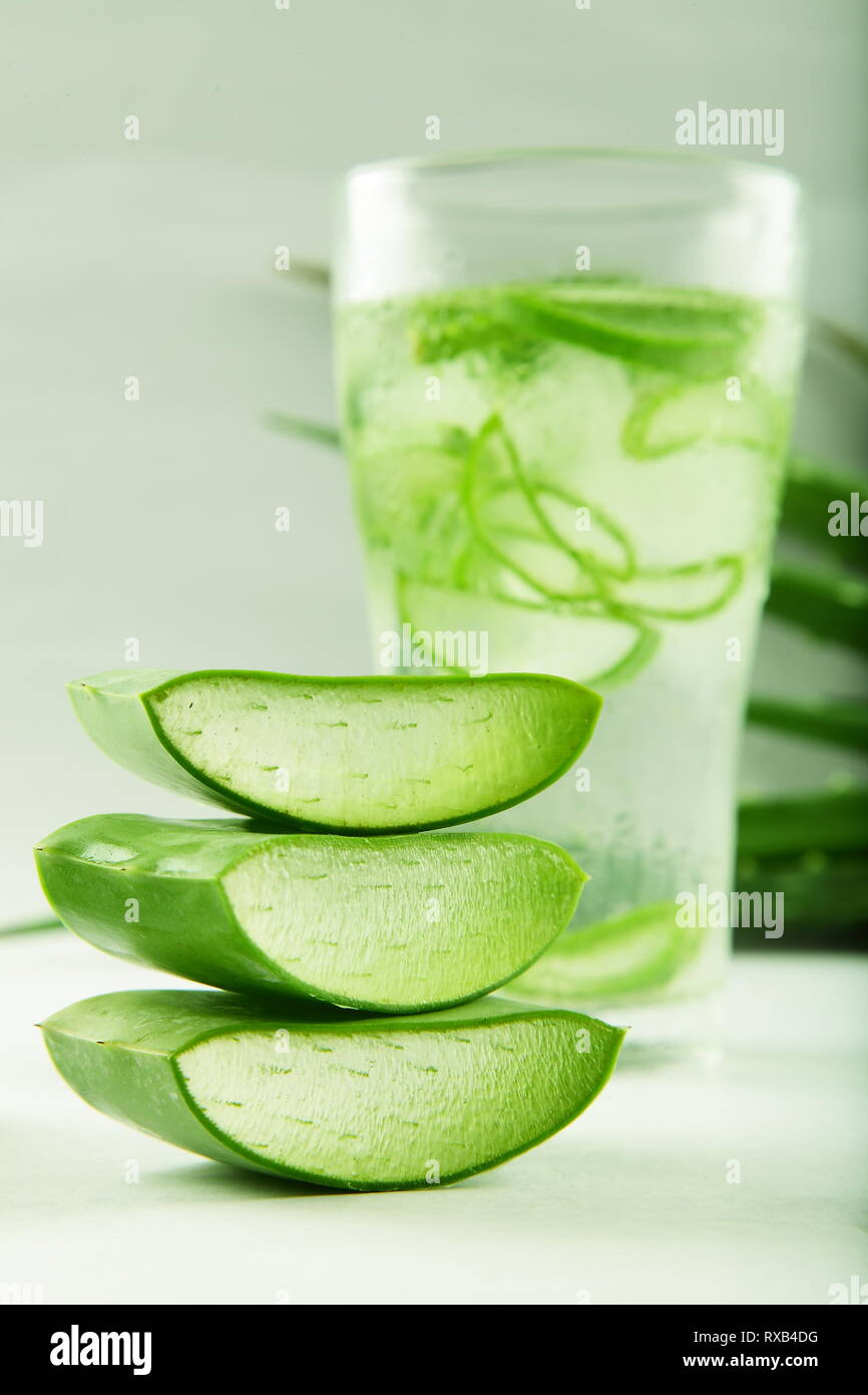 Glass of refreshing aloe vera juice served with slices of leaf Stock Photo  - Alamy