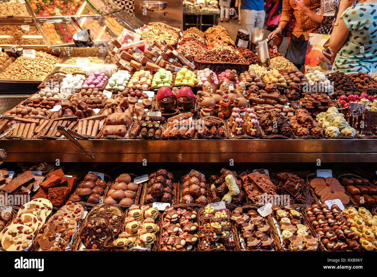 Various chocolate desserts for sale at a shop in the La Boqueria market