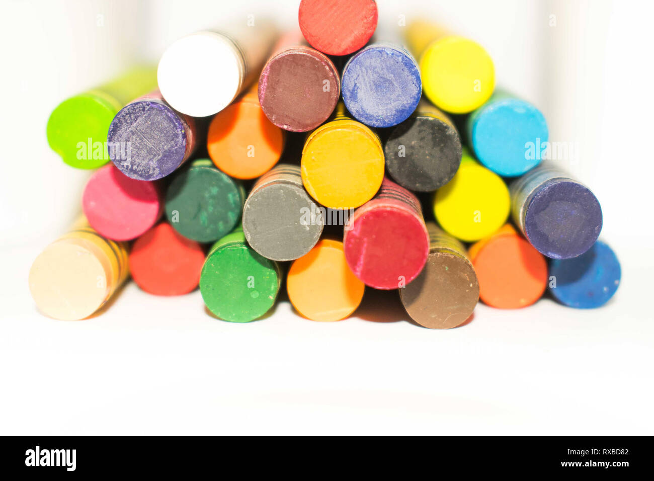 Colorful wax crayon pencils arranged in rows and columns. Vivid colors ...