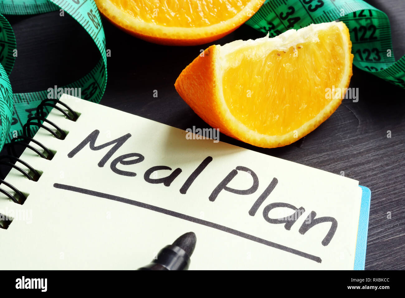 Meal plan concept. Note pad and measuring tape. Stock Photo
