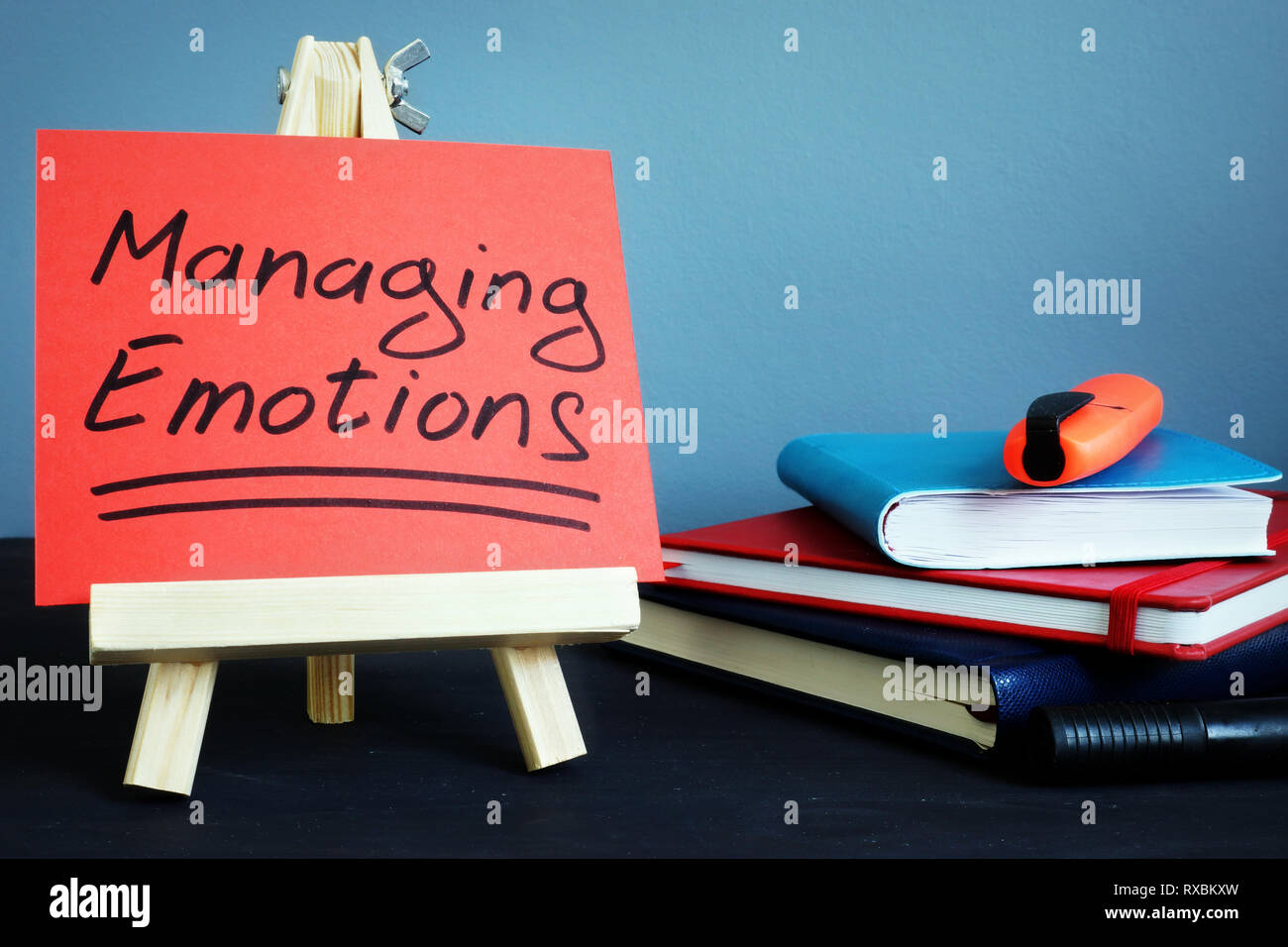 Managing emotions handwritten text on a piece of paper. Stock Photo