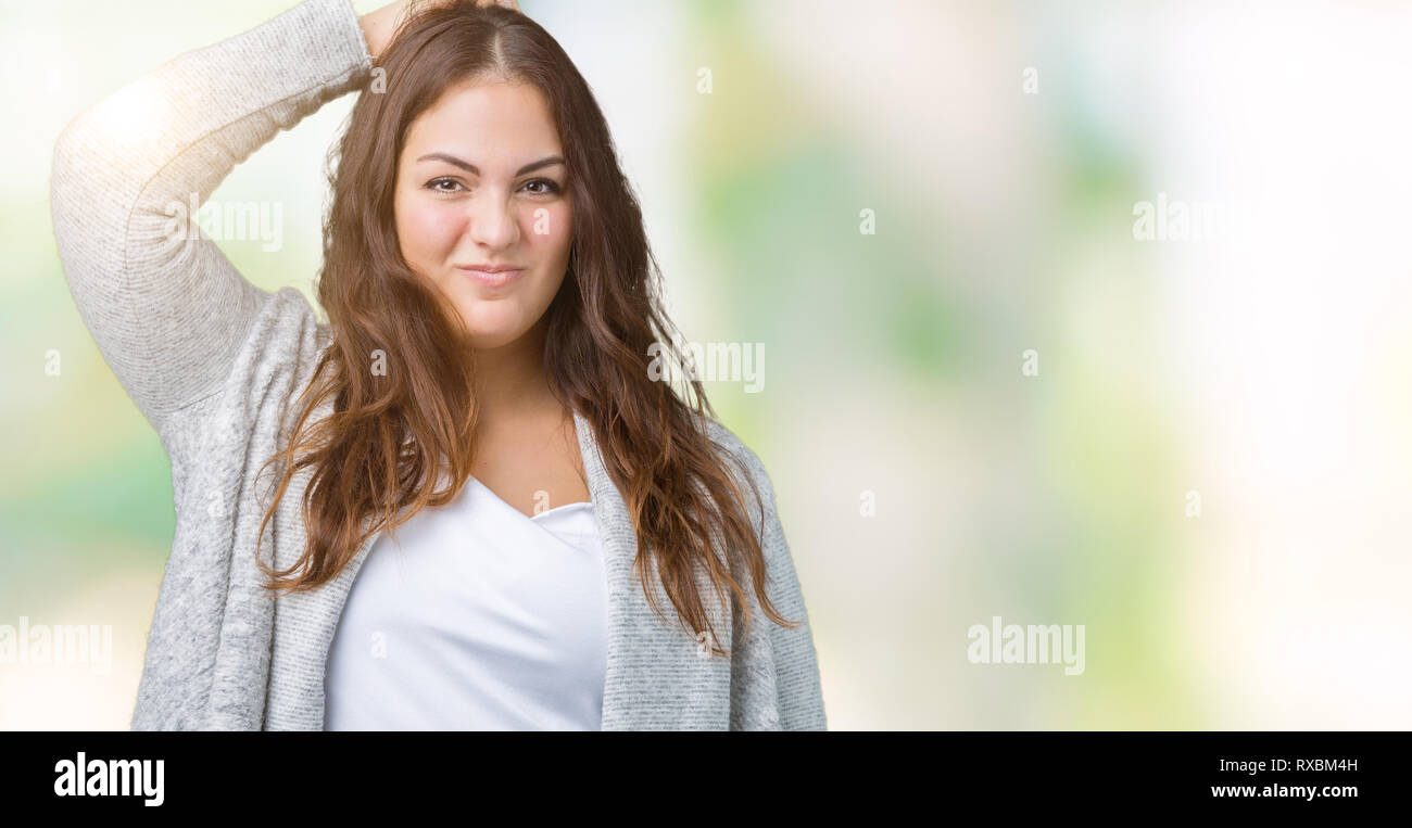 Beautiful plus size young woman wearing winter jacket over isolated background confuse and wonder about question. Uncertain with doubt, thinking with  Stock Photo