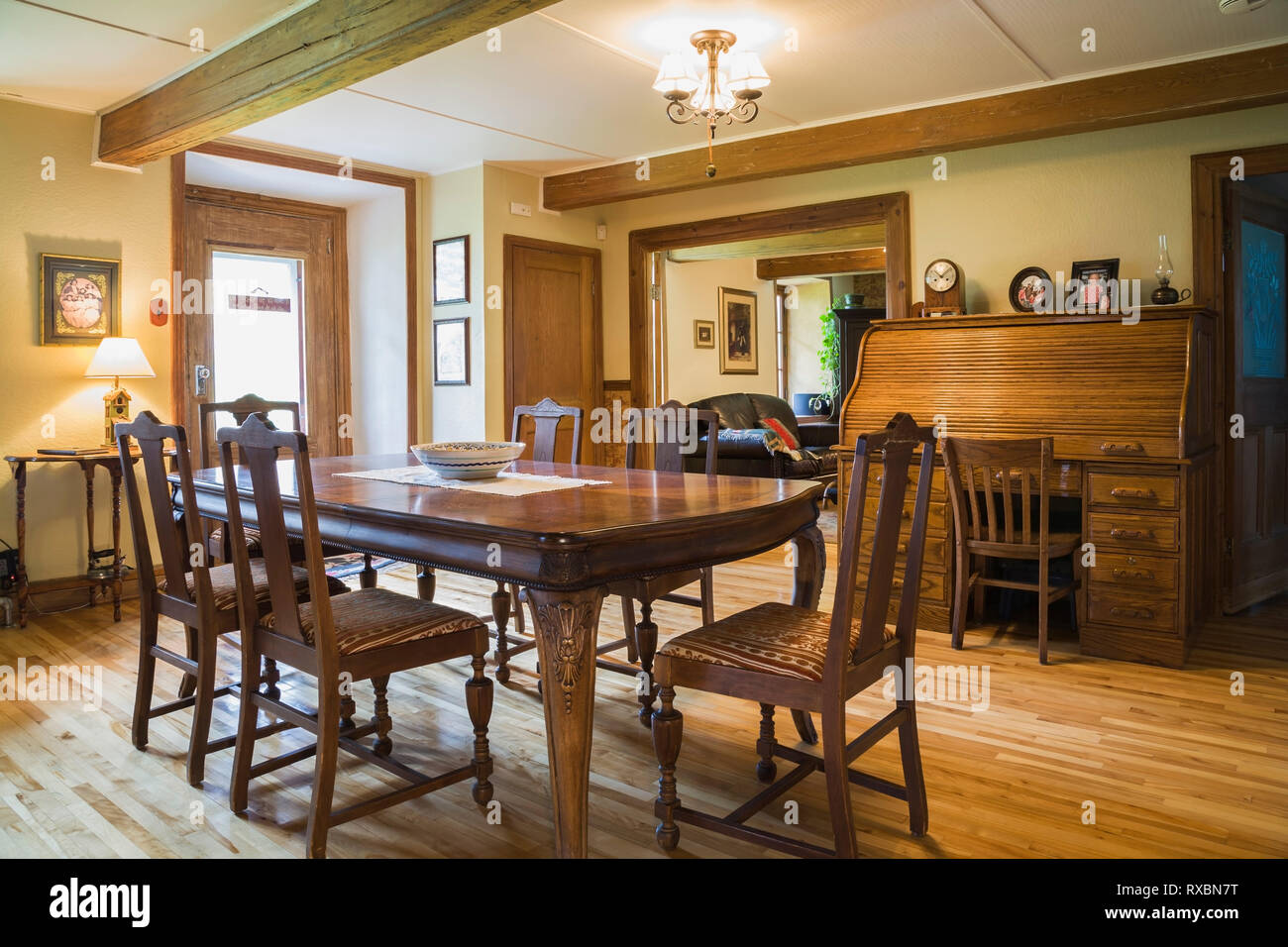 Dining Room With Antique Wooden Table And Upholstered High Back