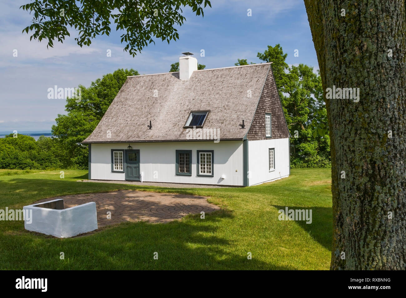 Rear View Of Old 1809 French Regime Cottage Style Home With White