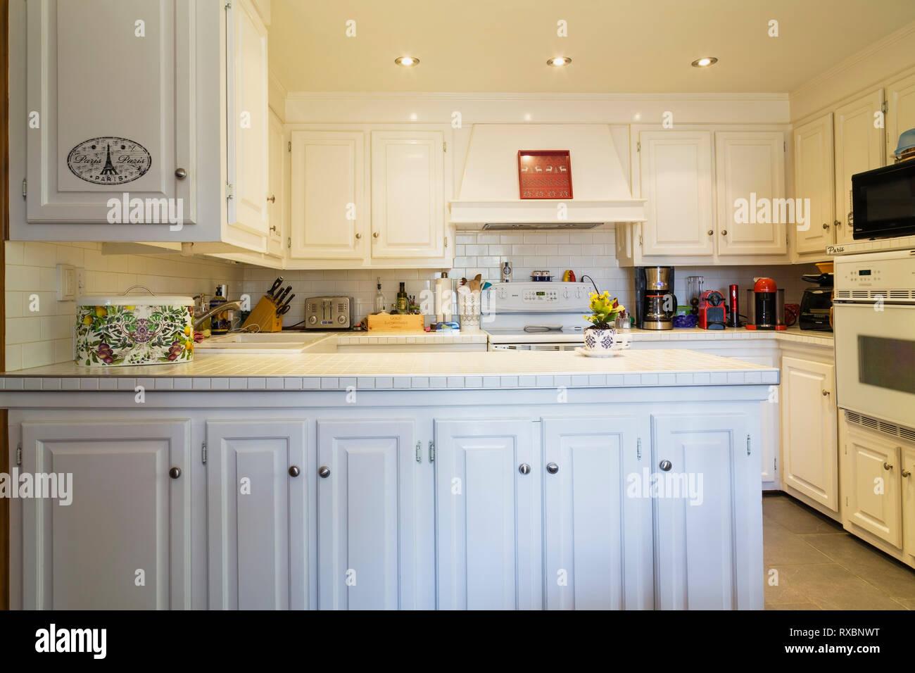 Country Style Kitchen With White Cabinets And Ceramic Tile