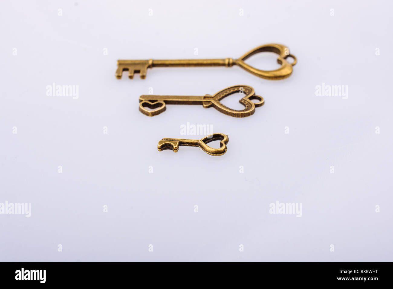 Heart shaped retro metal keys on white background Stock Photo - Alamy